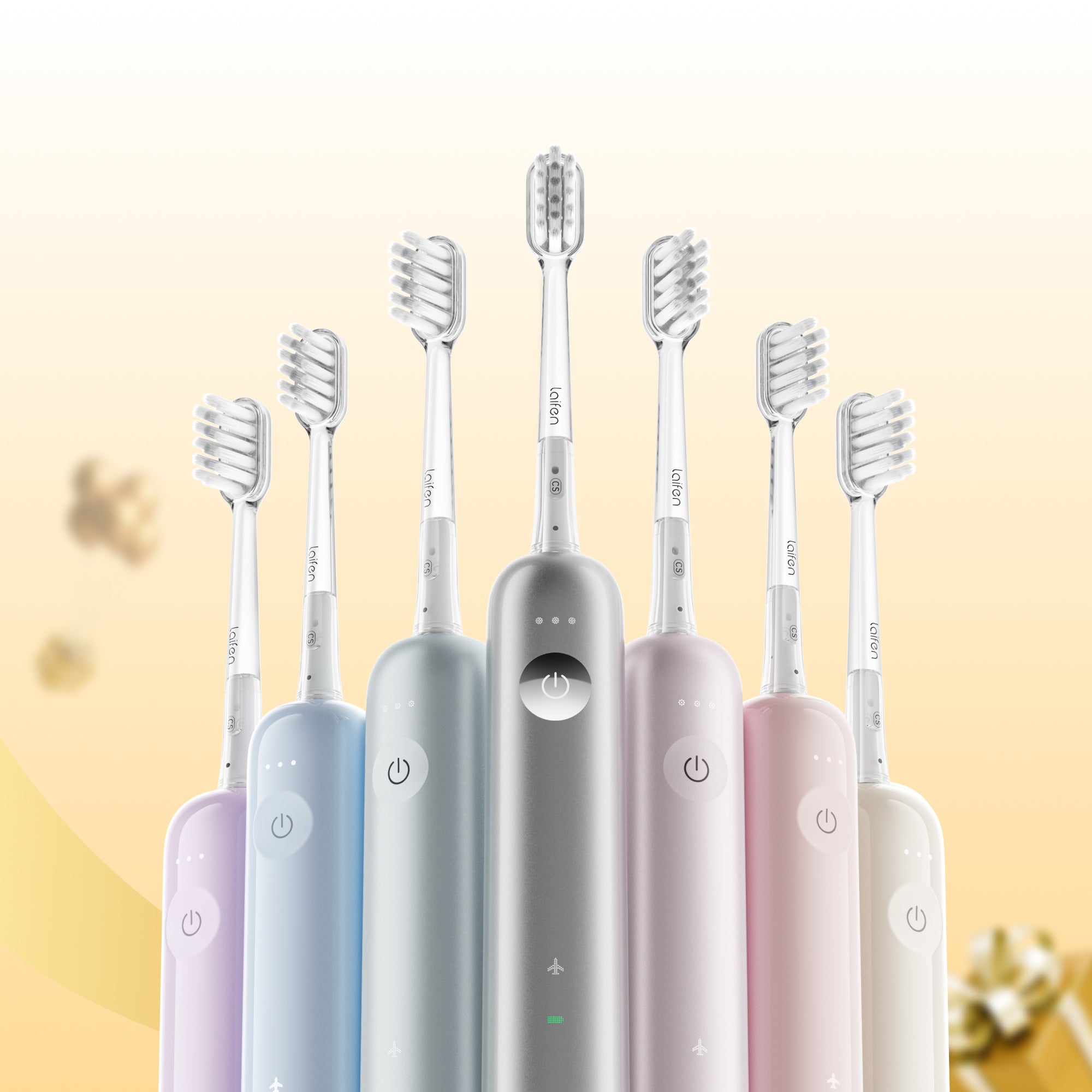 Set of six electric toothbrushes in different colors on a gradient background